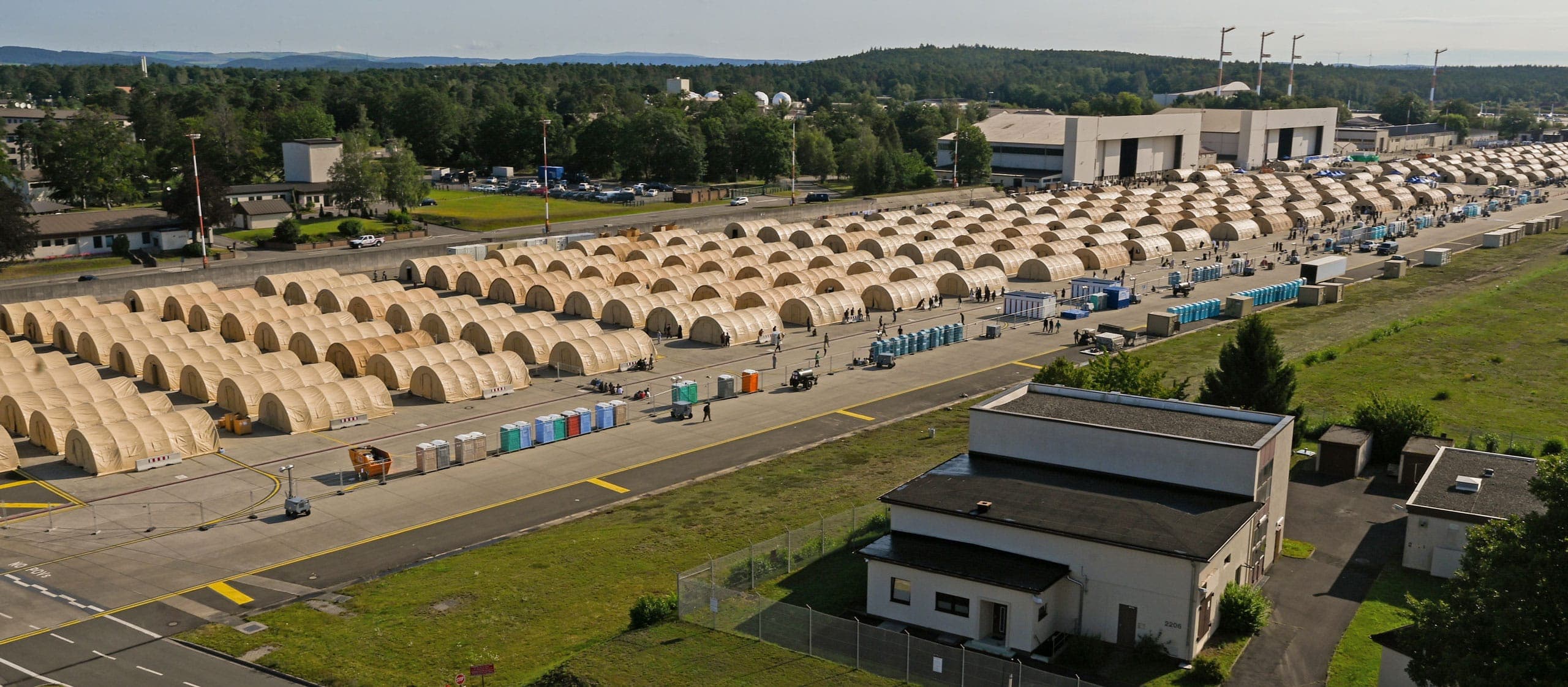 Military shelter systems from Alaska Defense deployed on the flightline of Ramstein Air Base